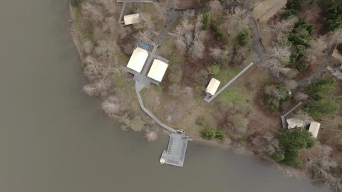 Drone Ascending Rotating above Riverside Glamping