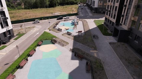 Drone Descending above Modern Housing Playground