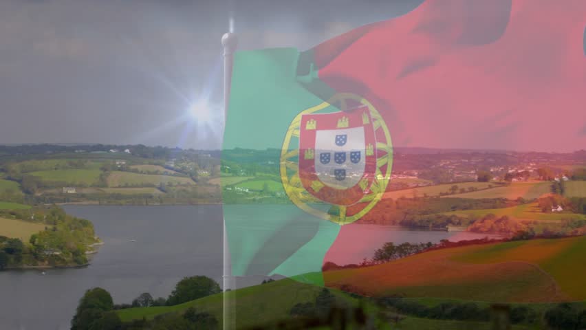 Mild breeze sending Portuguese flag waving and folding, creating transparent overlay across fields. European, ensign, tricolor, lensflare, doubleexposure, coastal, rural