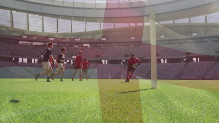 Male rugby player charging post defenders closing tackler wrapping ball popping trying to score. Stadium, turf, grass, athletes, outdoor, sunlight, competition
