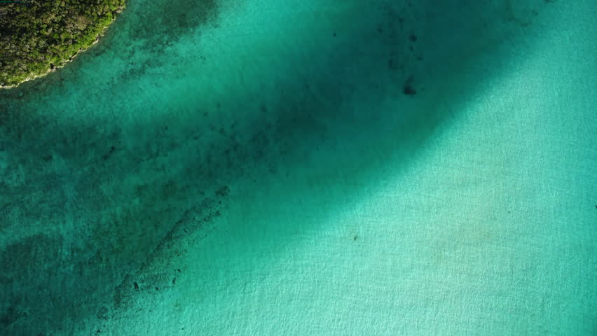 Bird's eye view of the crystal clear water and coastline of the Isle of Pines in New Caledonia