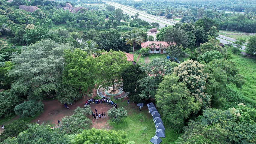 An aerial view of adventurers gathered at Ramanagara Hills resort for trekking through lush greenery enjoying nature adventure and scenic landscapes together