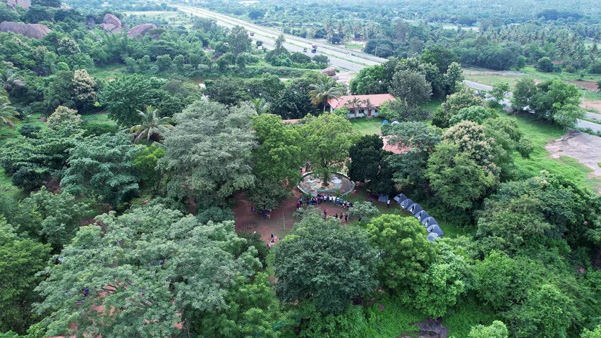 An aerial view of adventurers gathered at Ramanagara Hills resort for trekking through lush greenery enjoying nature adventure and scenic landscapes together