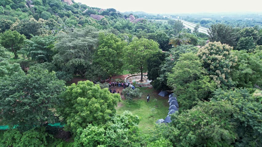 An aerial view of adventurers gathered at Ramanagara Hills resort for trekking through lush greenery enjoying nature adventure and scenic landscapes together