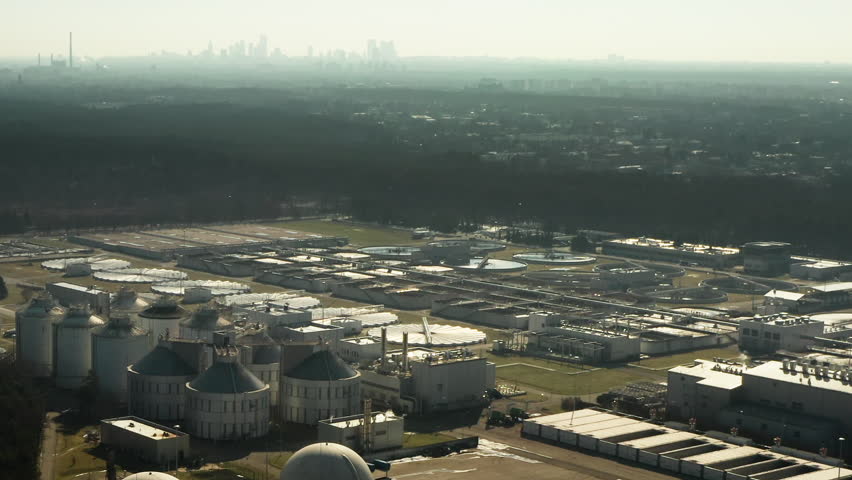 Large municipal plant processes urban sewage and liquid pollution through complex filtration systems to support capital city sanitation and environmental protection goals.