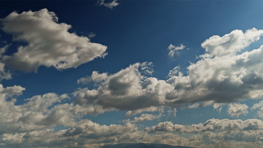 Soft rain clouds moving across the sky in timelapse, showing gentle atmospheric motion and changing weather patterns in a calm natural environment.