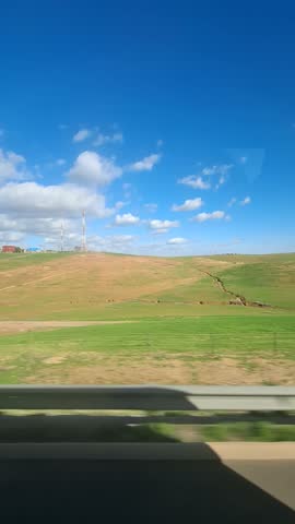Panoramic Vertical View of Rural Agricultural Landscape with Telecommunication Towers, Green Fields, and Farmhouses under a Blue Sky