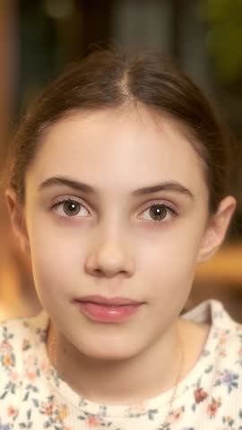 Portrait of a beautiful girl making different grimaces. Vertical video.