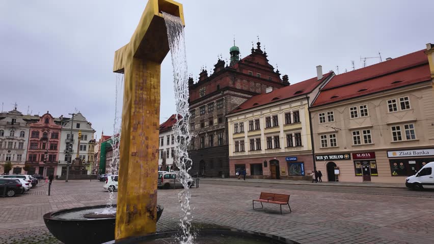 Street view around the city Pilsen in the Czech Republic  of the main market place on a cloudy autumn day beside the church