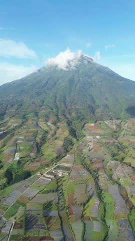 Aerial View of Mountain Terraced Farmland and Reservoir Near Village on a Clear Sunny Day