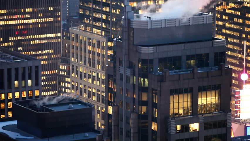 Smoke comes out on top of a skyscraper at dusk, Manhattan, New York City /