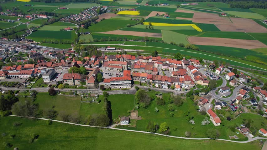 Aerial view around the old town of the city Romont  in Switzerland on a sunny noon in summer.