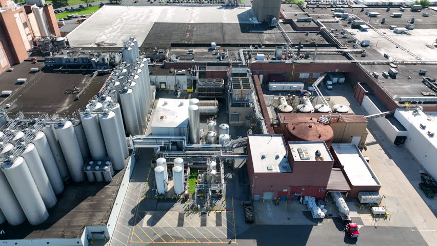 Beer brewery in USA. Aerial of stainless steel holding tanks for fermentation and distillation.