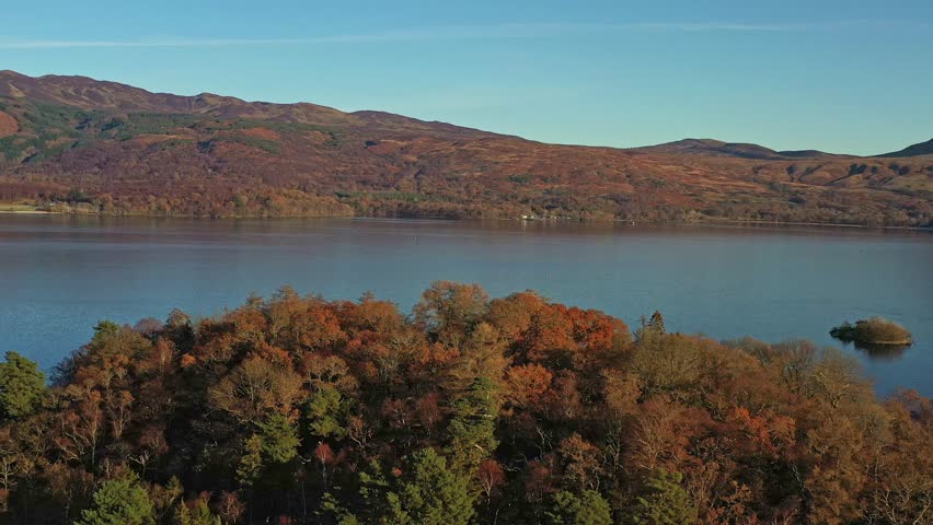 Scenic Aerial Panoramic Orbital Views Across Lock Lamond Lake During Autumn in Scotland.