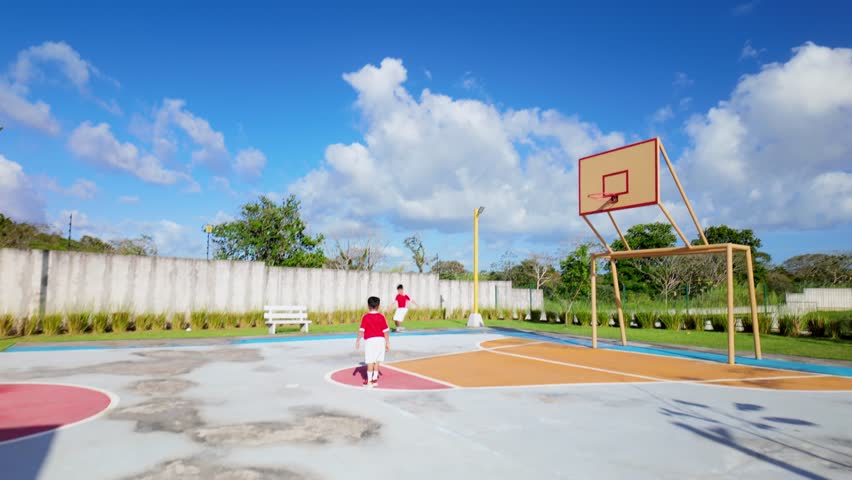 A group of children playing basketball in a park