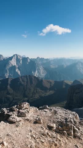 Man Climbing Toward Mountain Summit
Low-angle shot of male hiker ascending rocky path with Dolomites peaks behind.