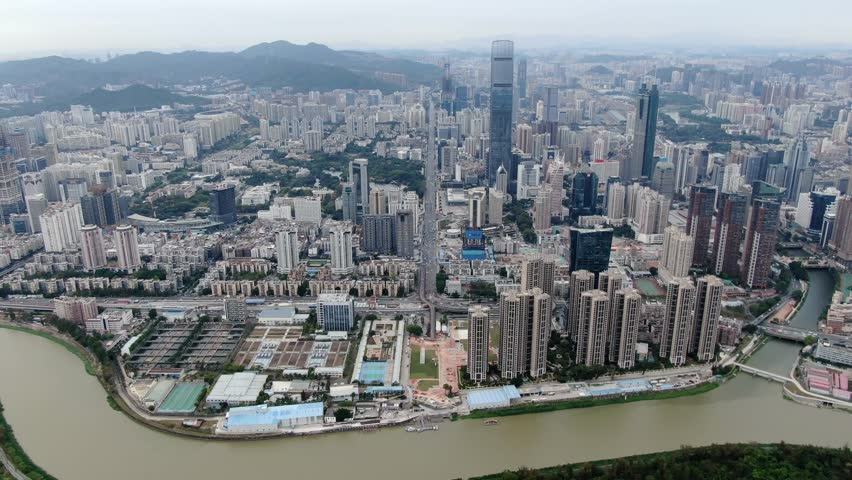 Aerial view over Shenzhen cityscape with massive urban development and skyscrapers.