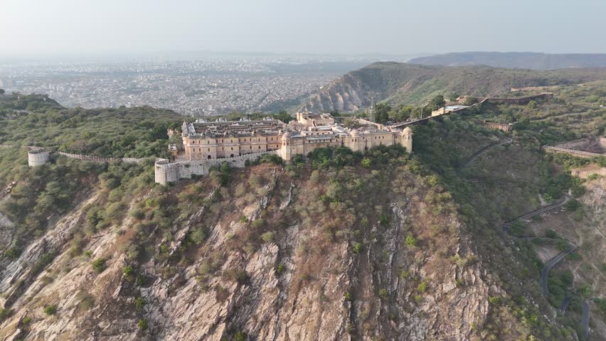 Drone flying beside Nahargarh Fort with panoramic view of Jaipur city in Rajasthan India.