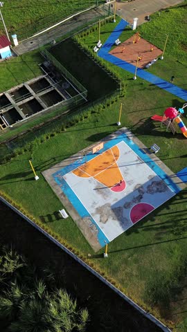 A park with a basketball court and a playground
