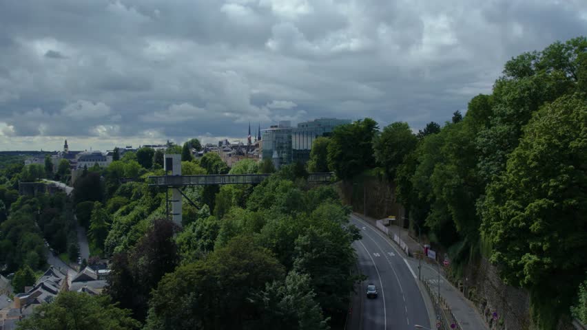 Street view around the city and capitol Luxembourg in the country Luxembourg driving  around the streets from top of a bus on a cloudy day in spring