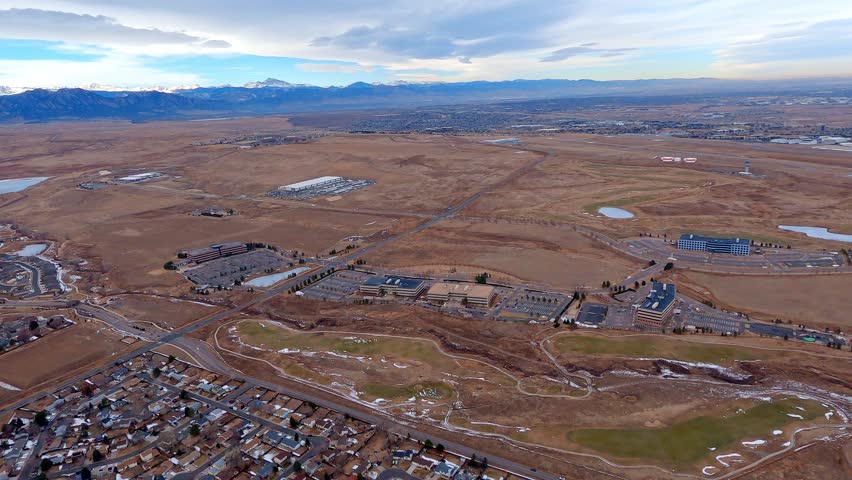 View of Rocky Mountain Metropolitan Airport from an airplane flying the downwind leg with Longs Peak in the distance