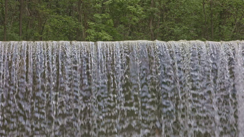 Water falls from man made cascade. Falling water close up. Cascatella waterfall near Novate Mezzola, Italy.