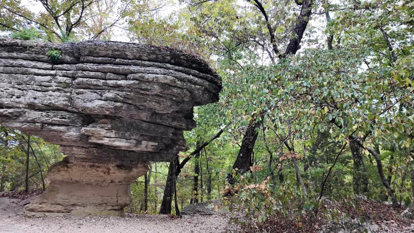 Ancient rock formation stands tall in forest clearing at Arkansas.