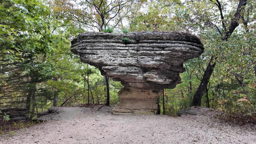 Ancient rock formation stands tall in forest clearing at Arkansas.