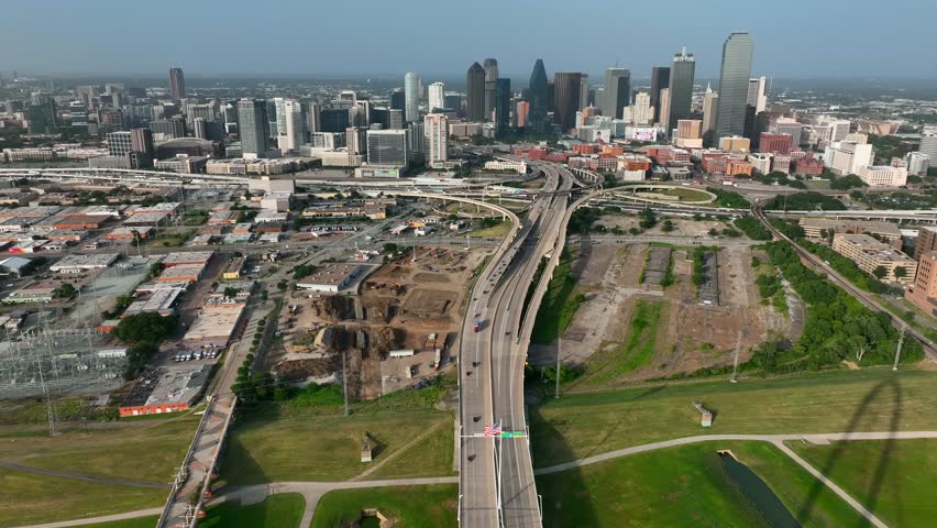 Wide aerial view of Dallas Texas skyline. Establishing shot at Margaret Hunt Hill Bridge during dusk.