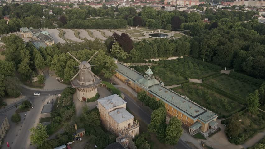 Aerial Circular view of the Sanssouci Palace, windmill above New Chambers museum in Potsdam