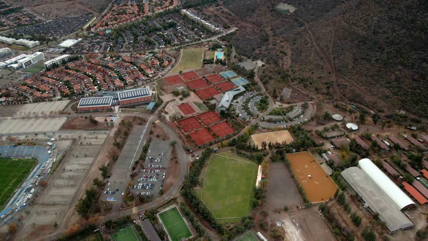 Aerial orbit of a clay tennis court in Las Condes, Santiago, Chile.