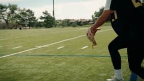 A female softball athlete fields a practice hit, catches it with her glove, and throws it downfield towards a soccer net while practicing on a football turf field. A truly epic sports shot. - Powered by Shutterstock - Get 15% off with code: PIKWIZARD15