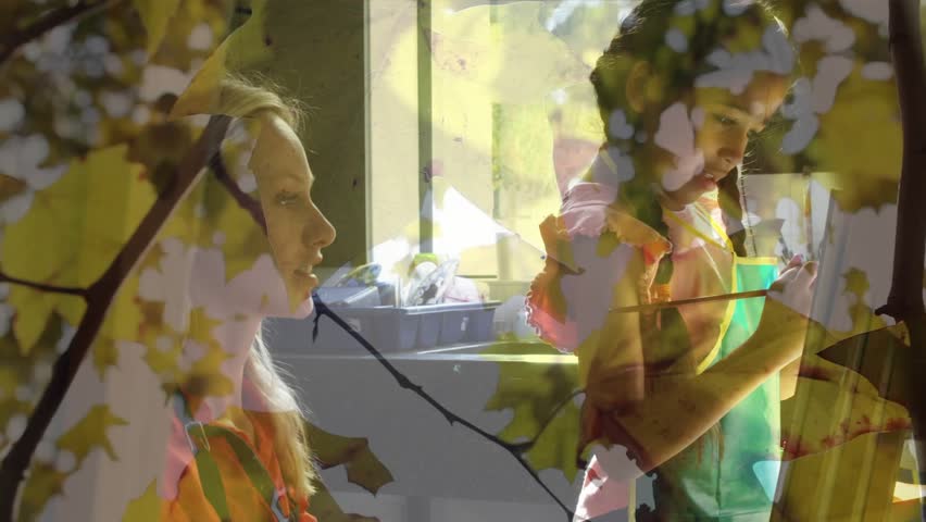 Child raising brush, painting while adult teaching in kitchen, leaf overlay shifting across scene. Family, kid, art, sunlit, window, focus, home