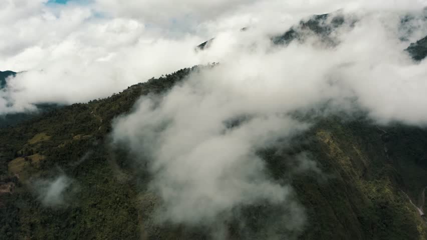 Thick Vapor Surrounding The Natural And Elevated Landscape Of Tungurahua Volcano In Baños de Agua Santa- Andes Of Ecuador. Wide Drone Shot