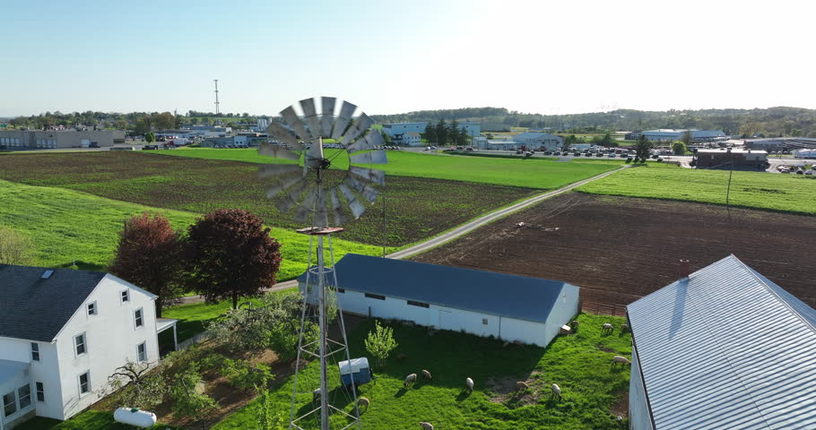 Amish farm and windmill in rural Lancaster County PA. Aerial tilt down.