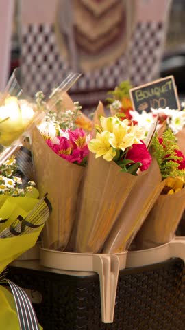 A slow panning shot of colorful flower bouquets displayed at an outdoor market in Manila
