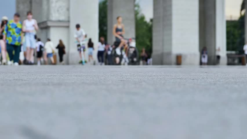 City sidewalk with blurred people walking, urban crowd movement and summer street life. Timelapse.