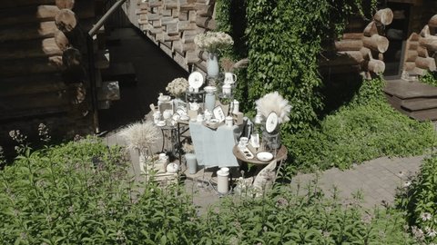Drone Orbiting Decorative Setup near Log House