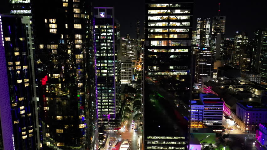 Aerial view night cityscape of Brisbane Australia. City lights, illuminated skyscrapers and business centers in urban city landscape, modern architecture travel and tourism.