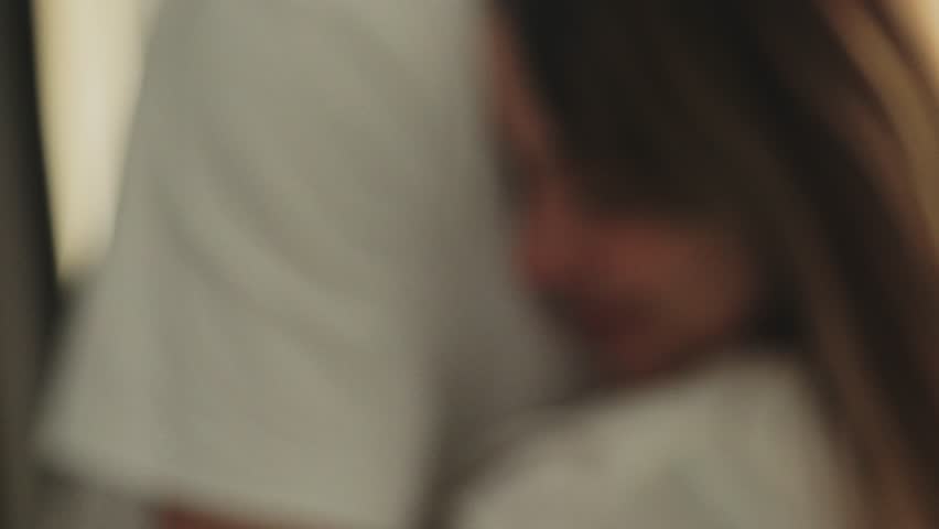 A young woman and man are shown in a close, tender embrace. They are holding each other tightly with expressions of comfort and love. Ideal for romantic, family, or emotional support themes.