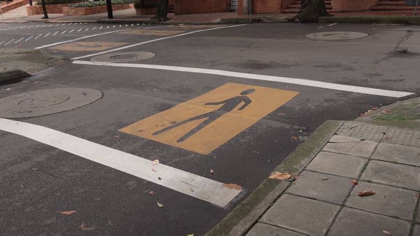 Pedestrian crossing on a road, marked with yellow in Bogota Colombia South America