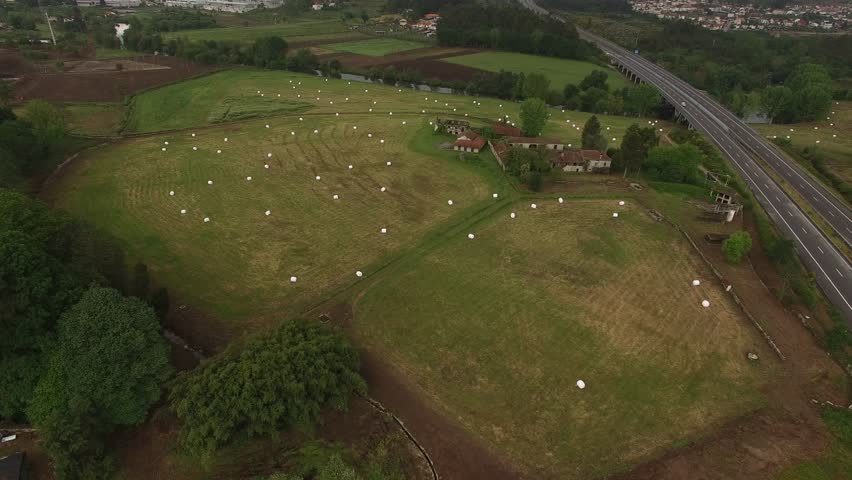 Farm field with hay bales