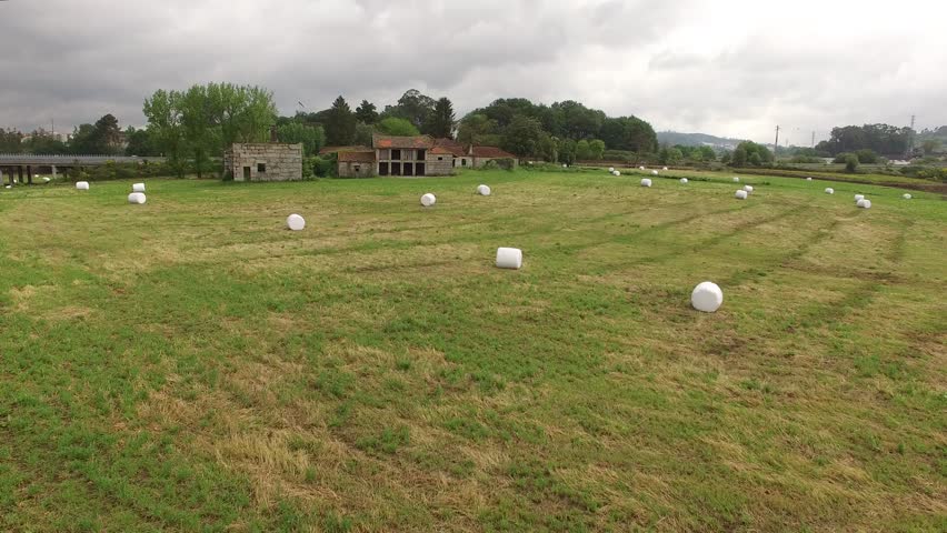 Farm field with hay bales