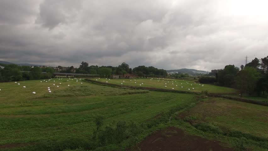 Farm field with hay bales