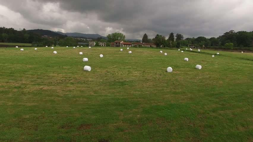 Farm field with hay bales