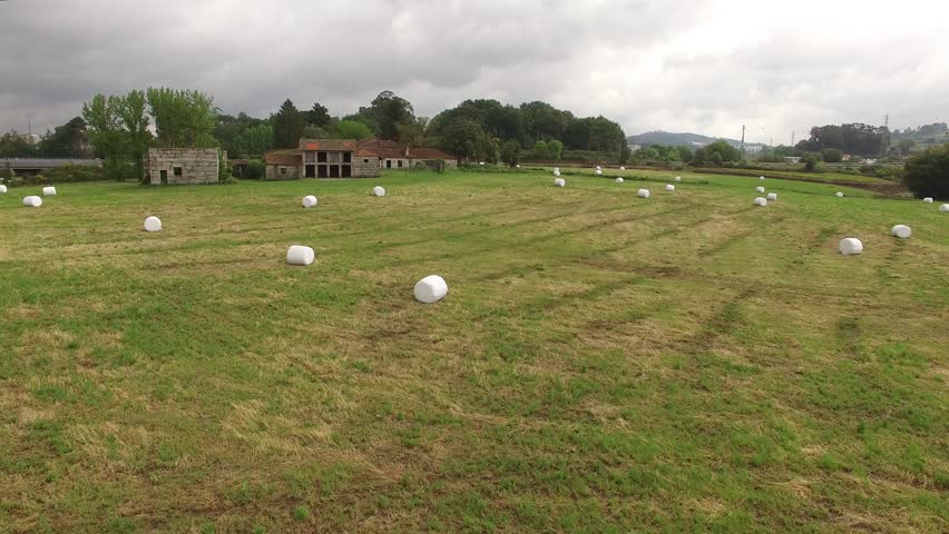 Farm field with hay bales
