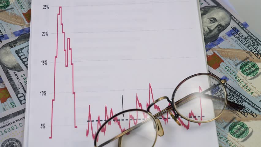 US $100 bills slowly spinning around their axis. View from above.