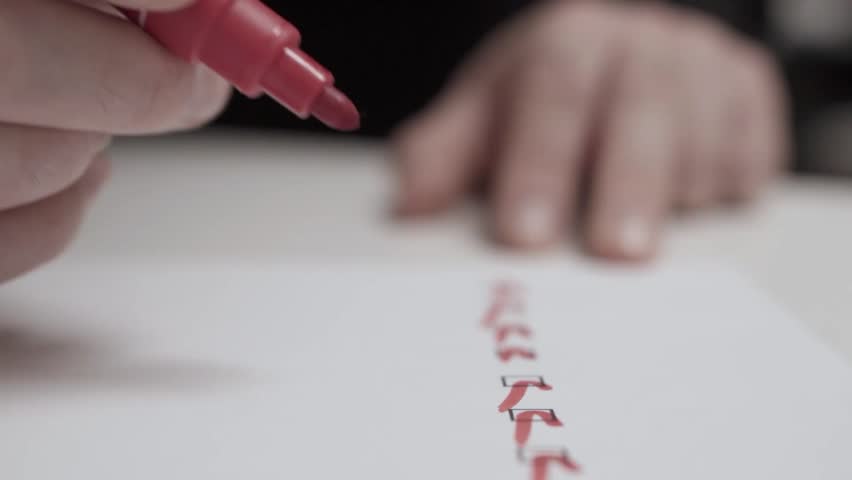 Close-up of a hand using a red marker to check off completed tasks on a to-do list. Strong visual for productivity, goal setting, time management, planning, progress tracking, and daily organization.