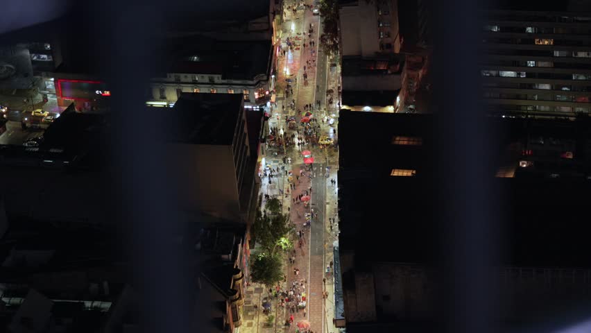 Major walking street in Bogota COlombia at night, viewpoint busy crowded with people