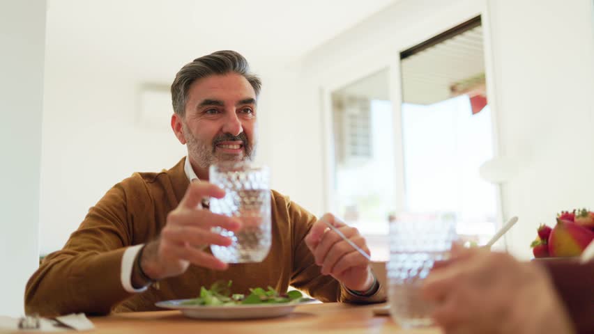 Mature man enjoying a healthy green salad meal at home